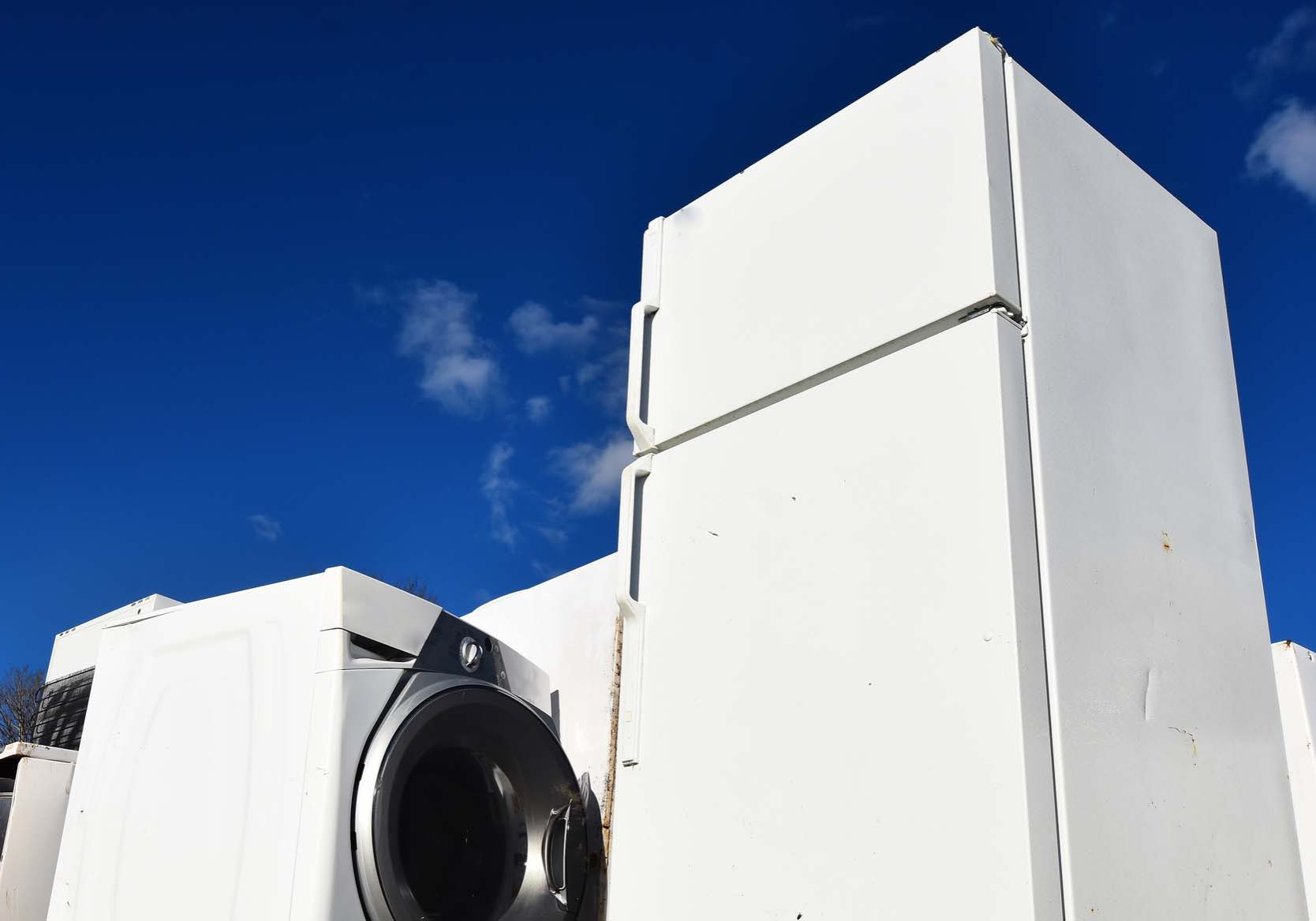 Old and Used Appliance Recycling. An image of several old and used appliances at a recycling facility.