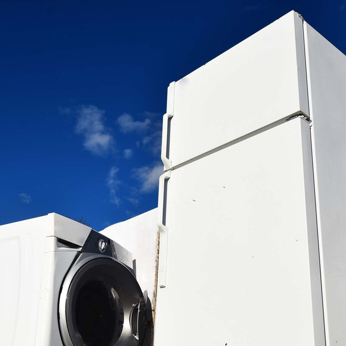 Old and Used Appliance Recycling. An image of several old and used appliances at a recycling facility.